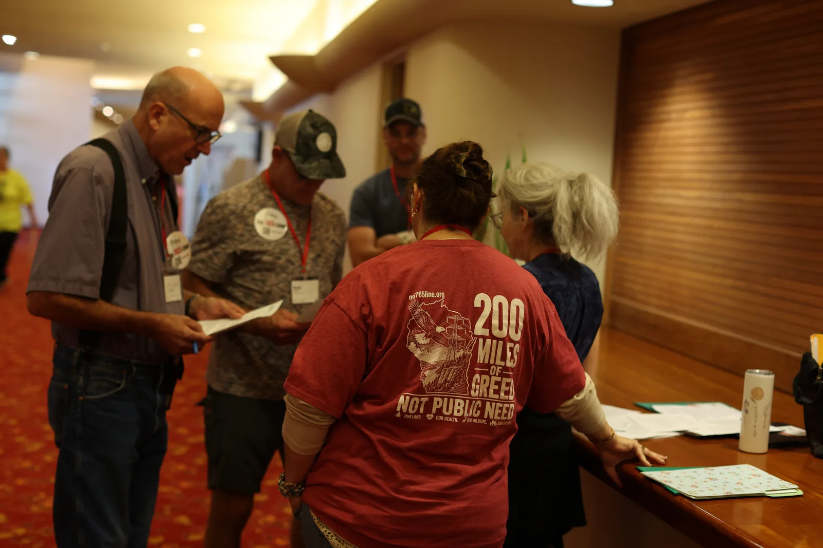 Photo 10 of 34. Residents gather in the hallway before heading to the Capitol, one in a 200 miles shirt.