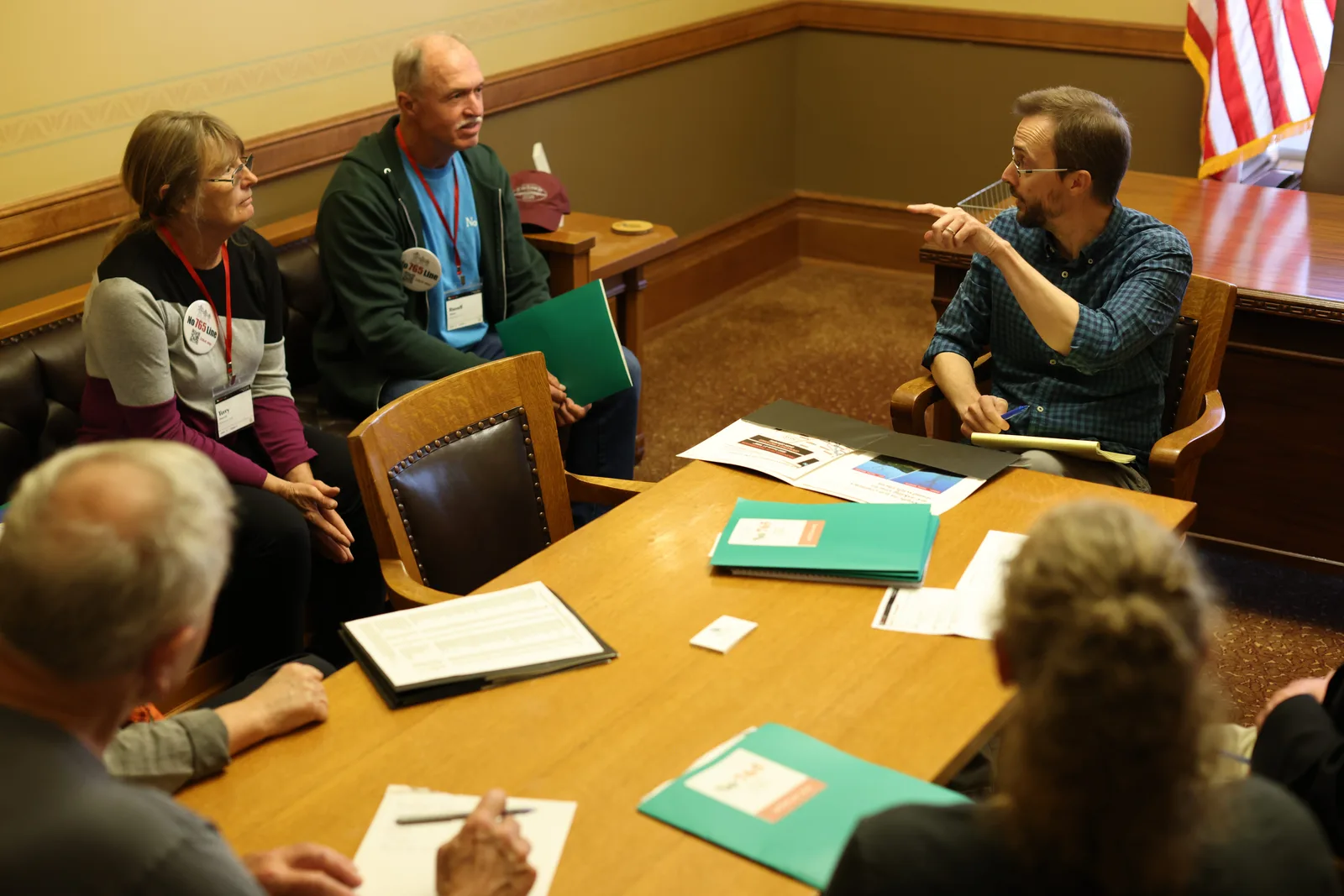 Photo 13 of 34. A team listens as a staffer talks through the requests in a legislator's office.