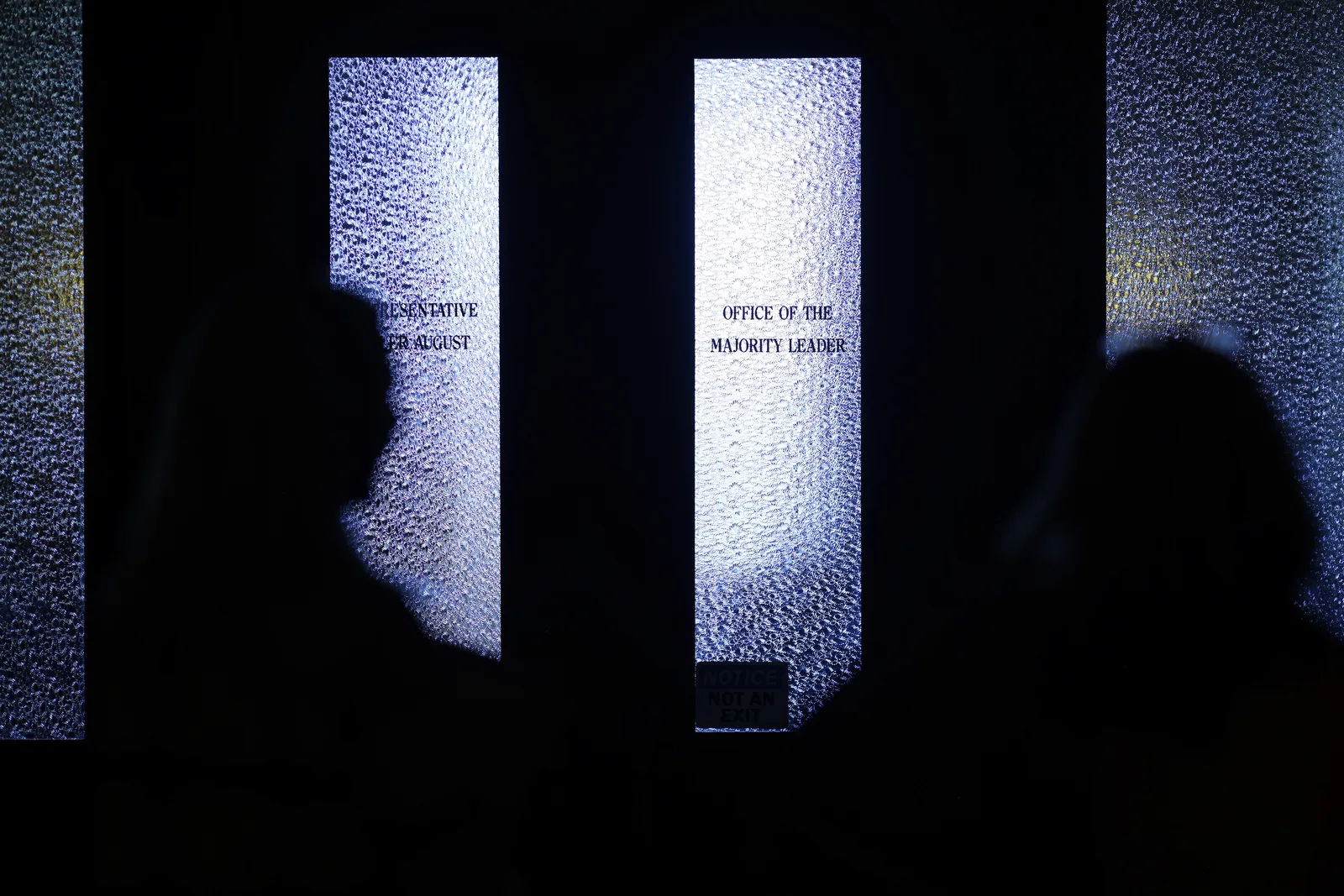 Photo 15 of 34. Residents in silhouette outside the door of the Office of the Majority Leader.