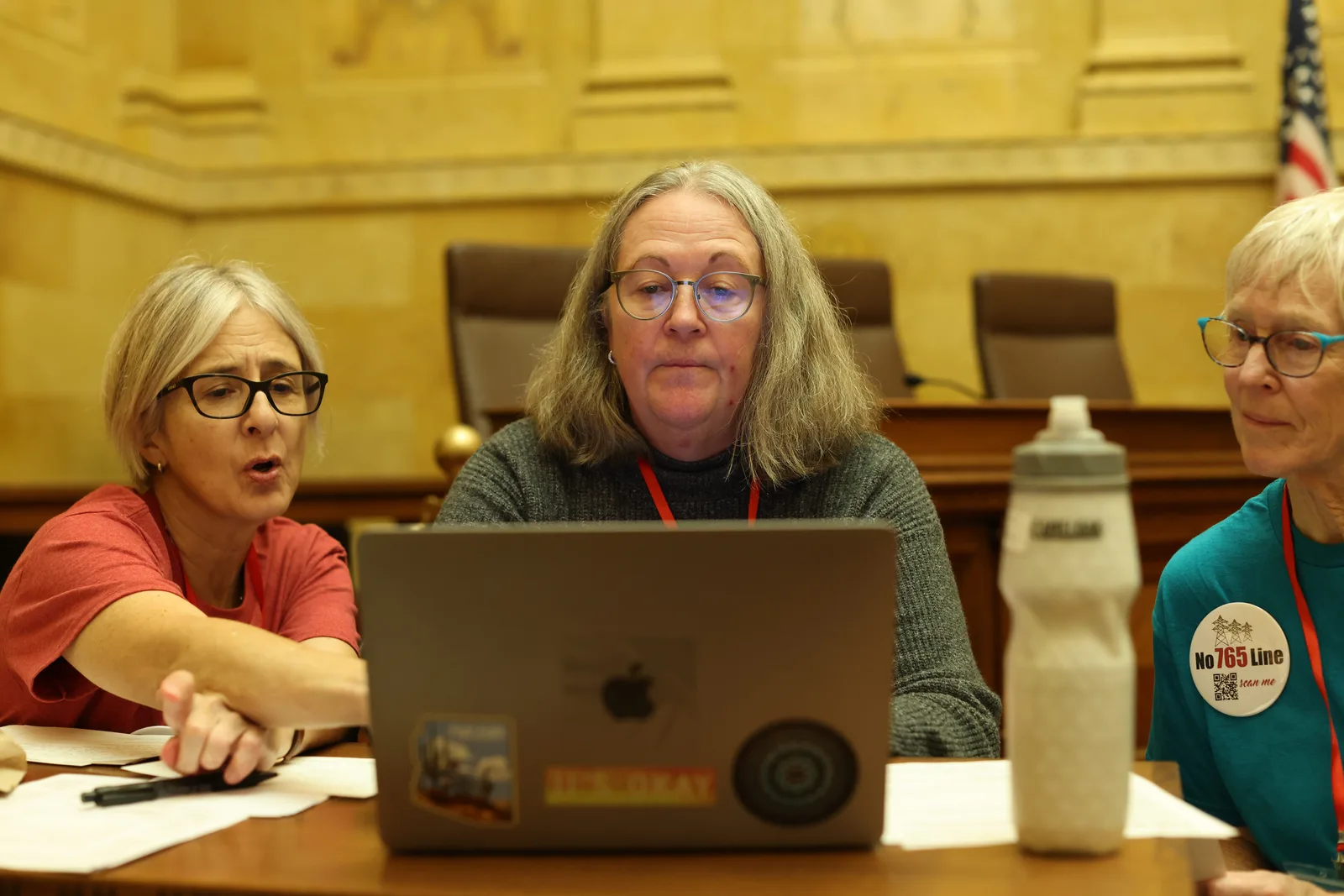 Photo 20 of 34. Volunteers work at a laptop in the hearing room that served as the day's command post.