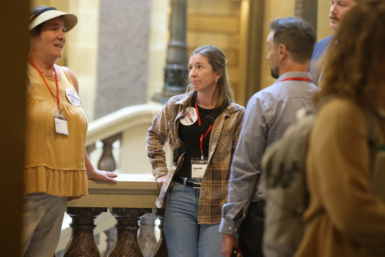 Photo 21 of 34. Residents talk at the Rotunda railing between meetings.