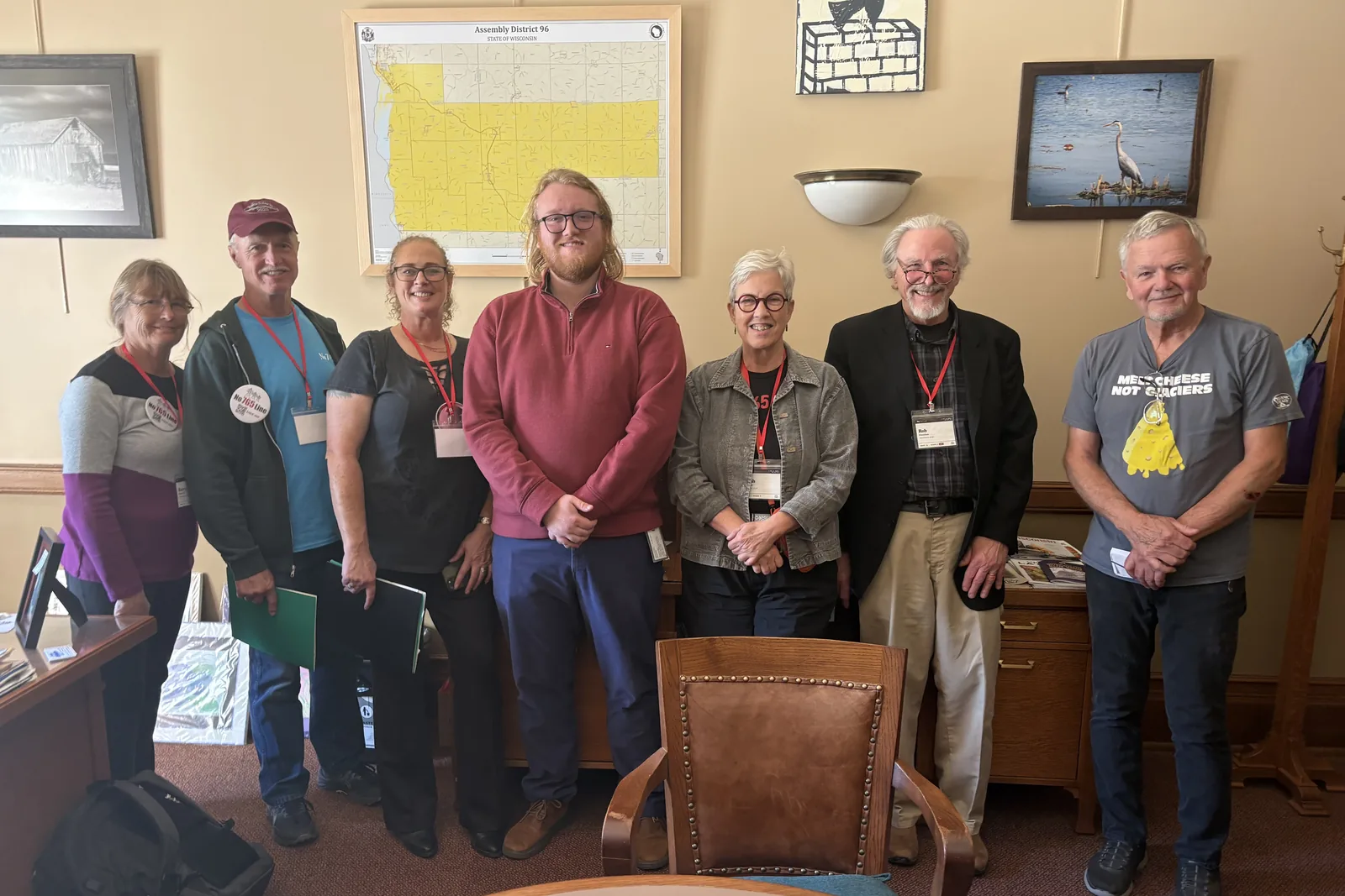 Photo 19 of 34. Residents with staff in Rep. Tara Johnson's office, under a map of Assembly District 96.